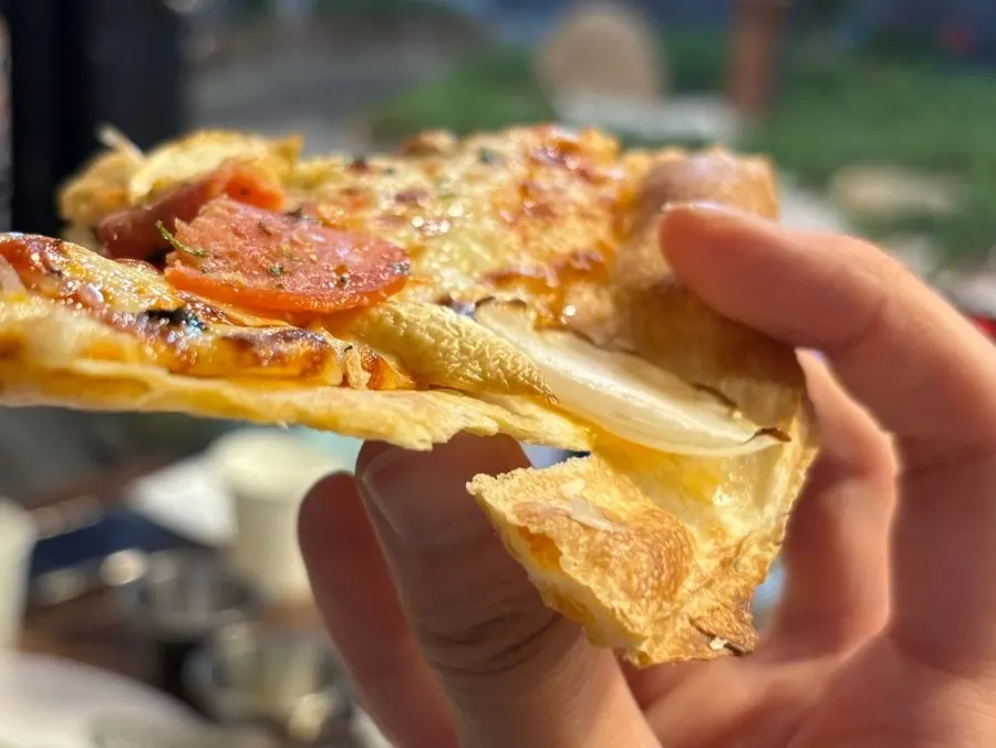 Pizza with tomato sauce underneath