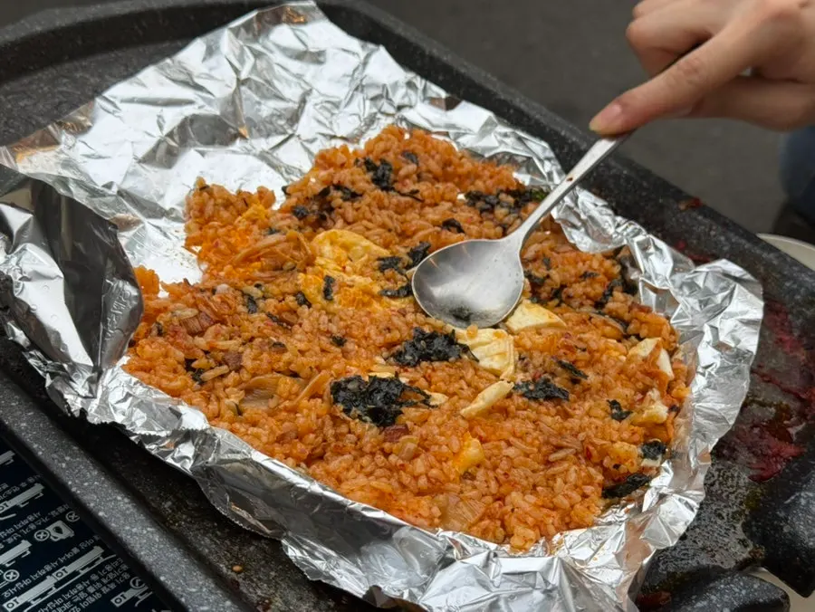 Kimchi fried rice topped with a fried egg and seaweed flakes