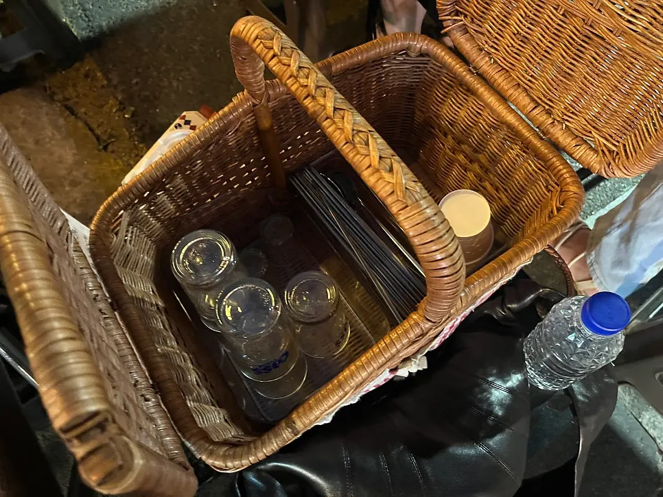 Basket between tables with spoons and glasses