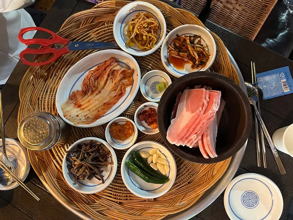 Frozen pork belly grilling on the barbecue plate