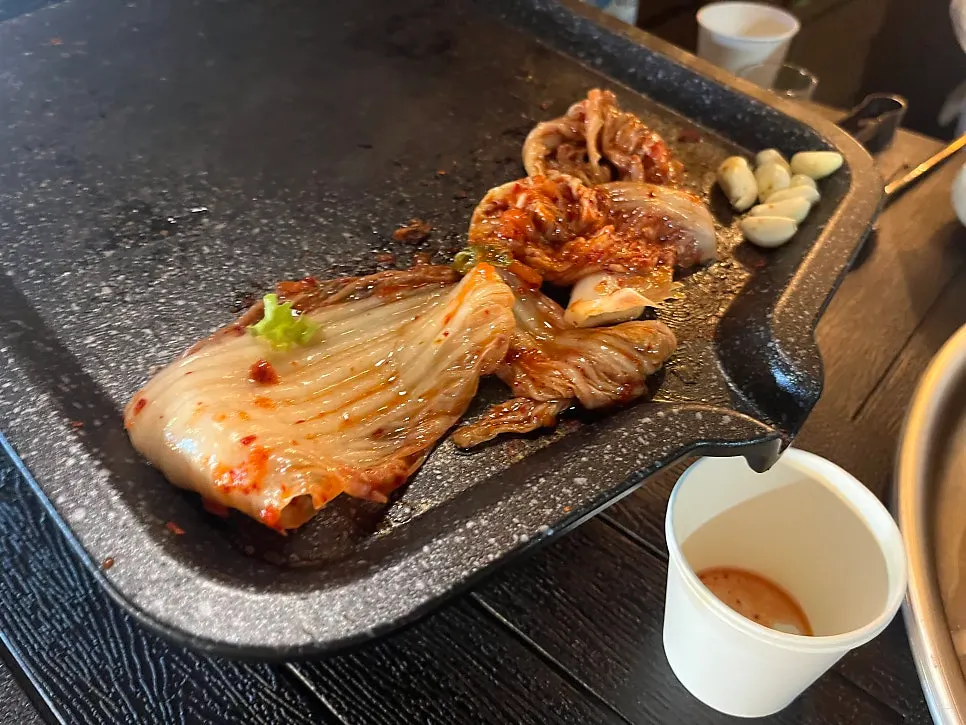 Pork belly on the grill with side dishes
