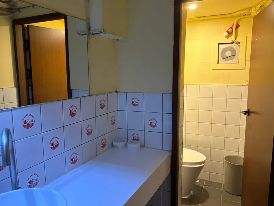 Restroom with hand sanitizer and hand towels
