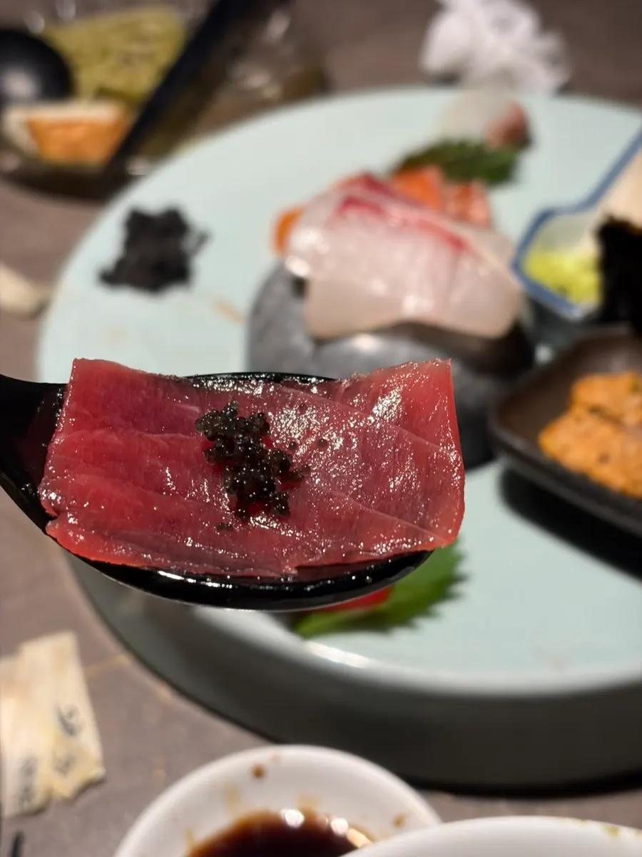Sashimi topped with black flying fish roe
