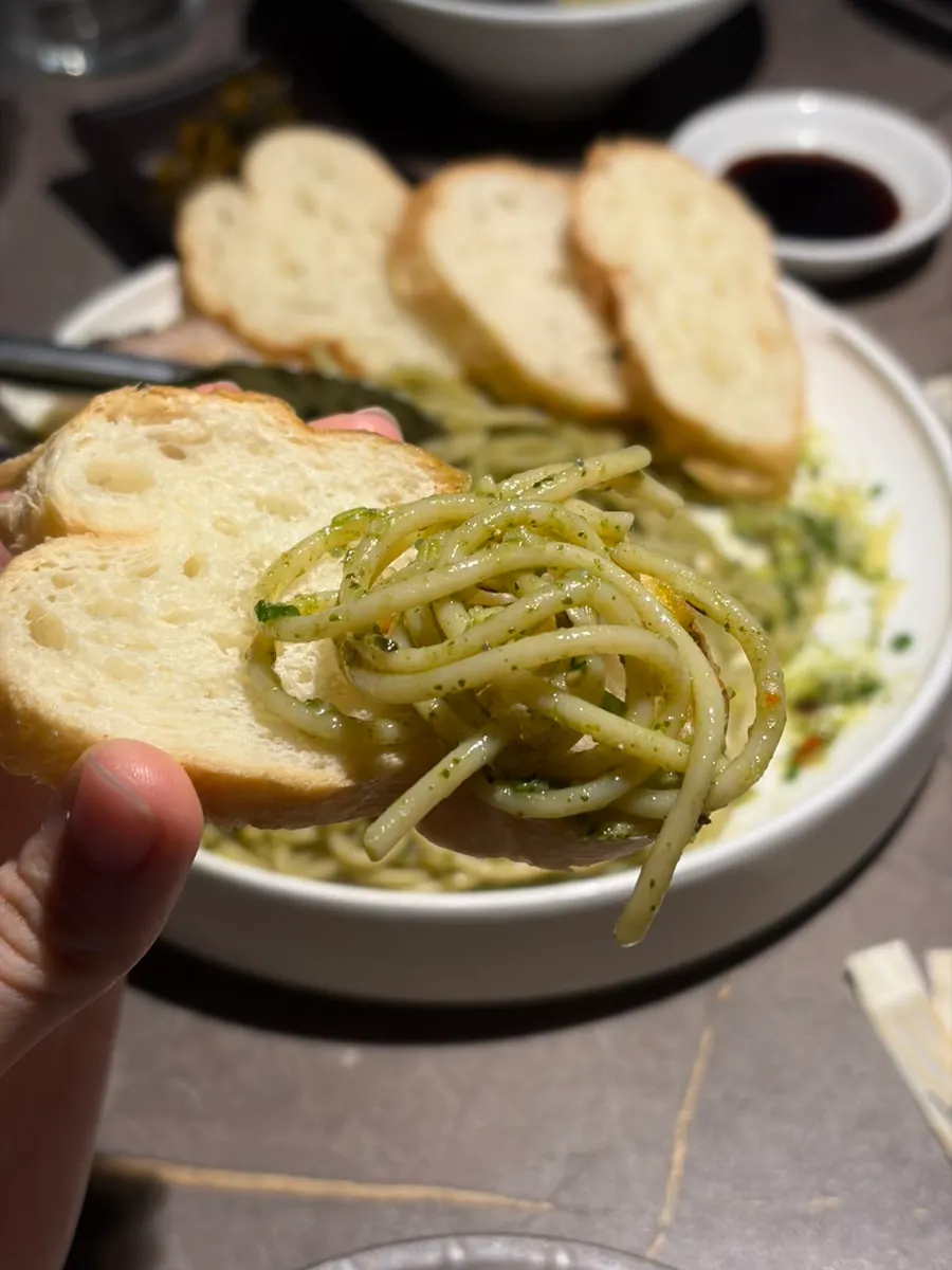 Basil-heavy pasta with baguette bread
