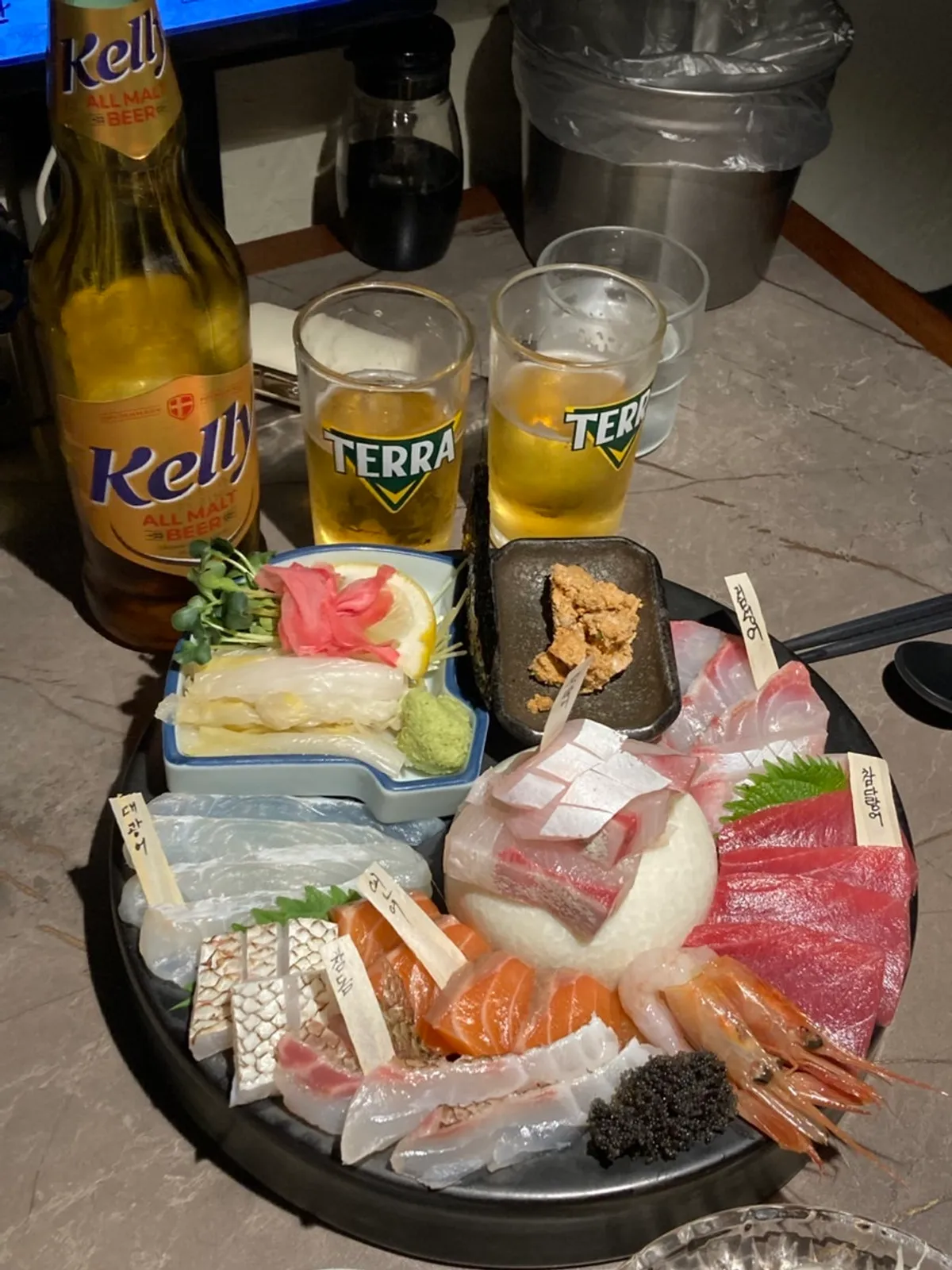 Table spread with aged sashimi and crab roe stew