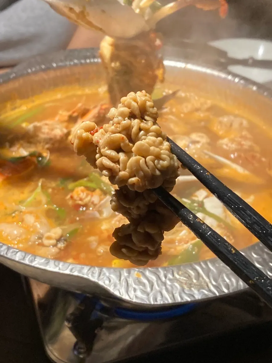 Broth of the crab roe stew packed with tomalley and roe