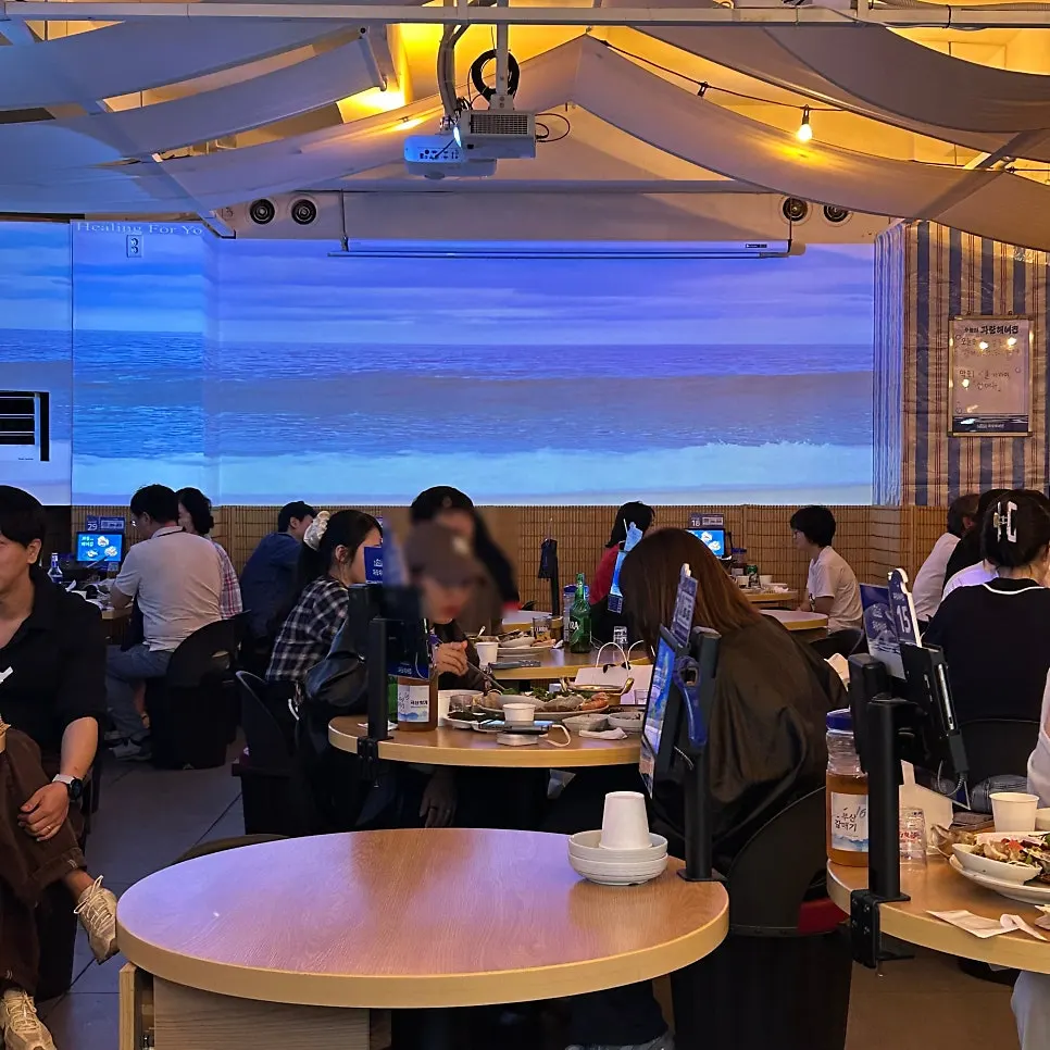 Dining seats at Parang Haenyeojip with soft lighting