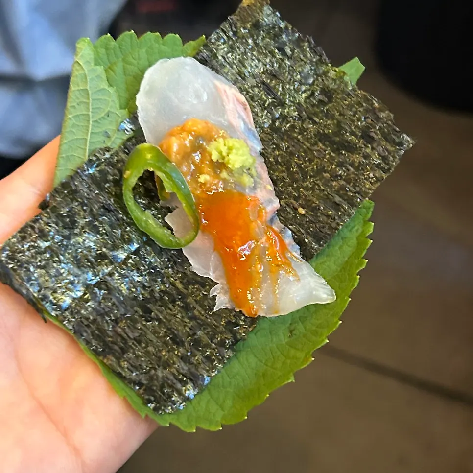 Seaweed and perilla leaves served alongside the sashimi