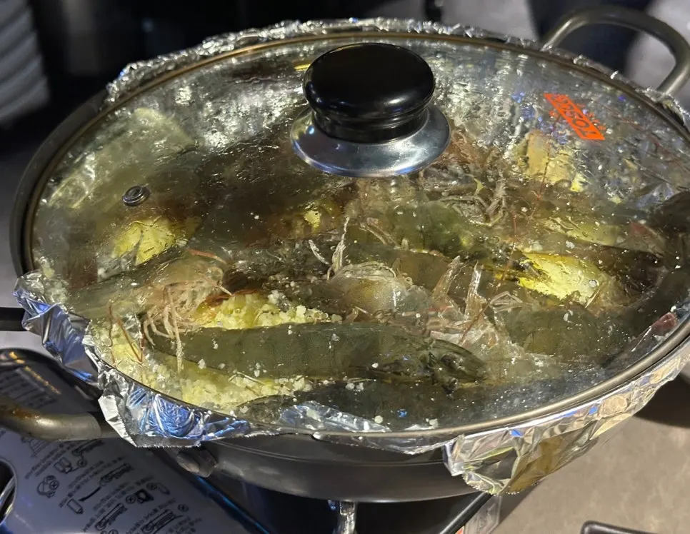 Seasonal autumn salt-grilled shrimp on a bed of salt