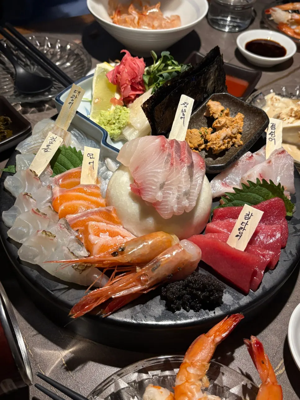 Final spread of aged sashimi and shrimp dishes