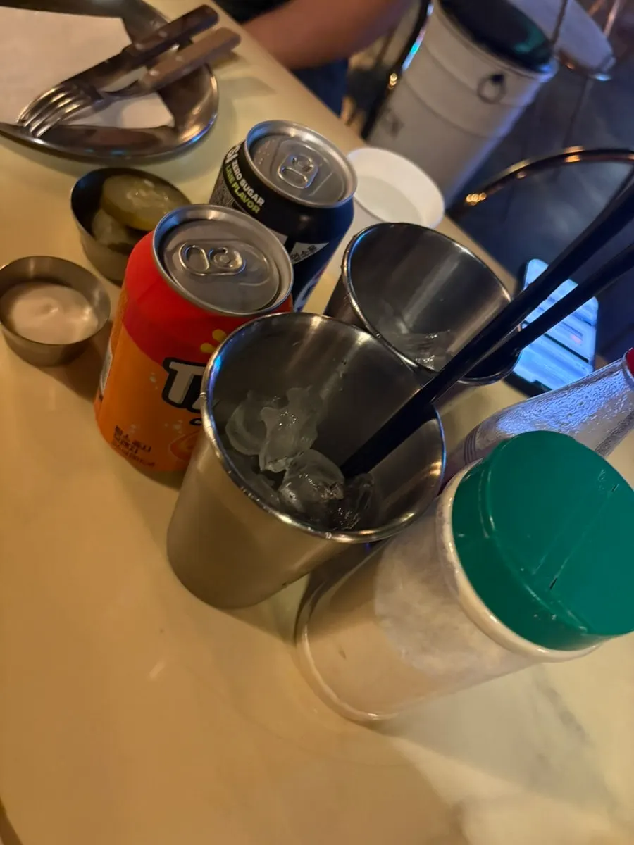 Self bar with water, hot sauce, and parmesan powder