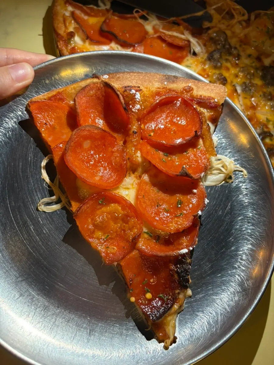 A pizza slice on a plate