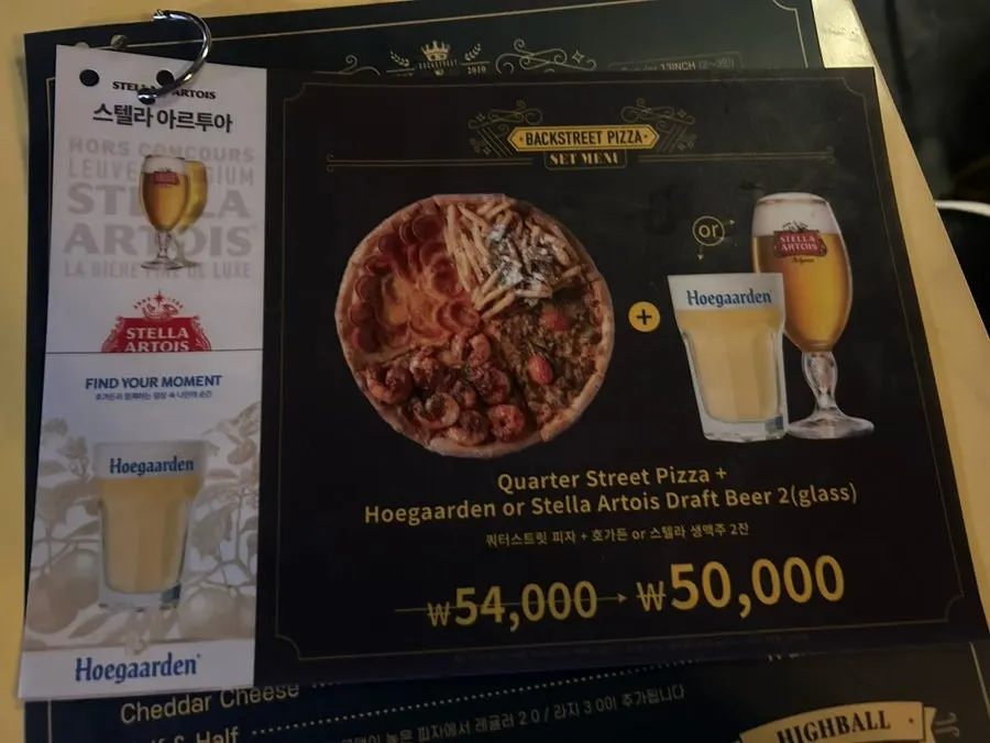 Backstreet Pizza's menu board, from regular to large sizes