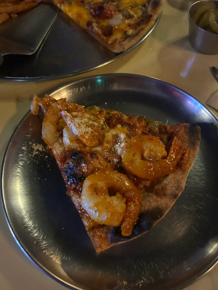 Slices from the quarter pizza laid out for comparing four flavors