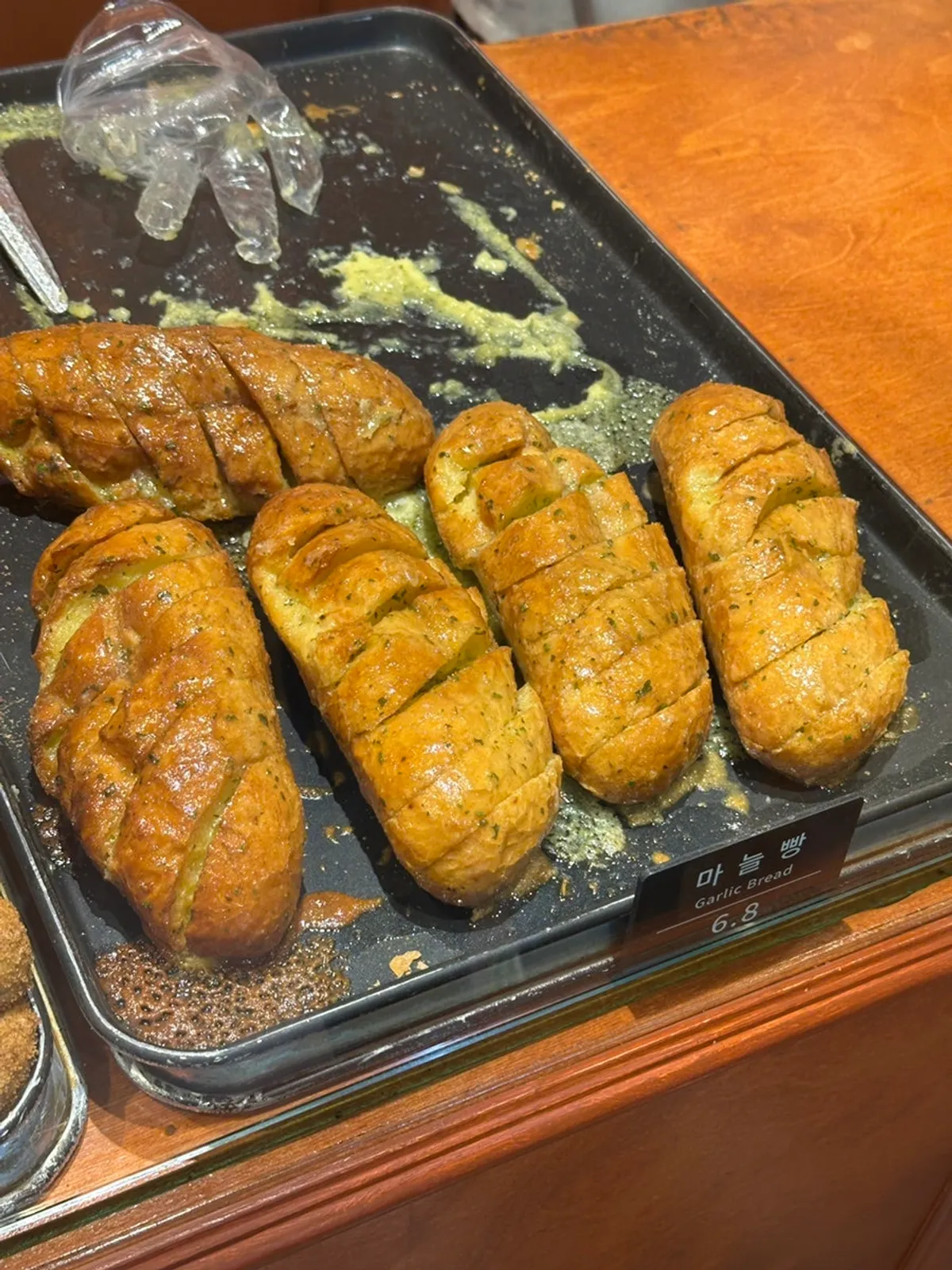 Various types of bread on the display shelf at Munhwa Bakery