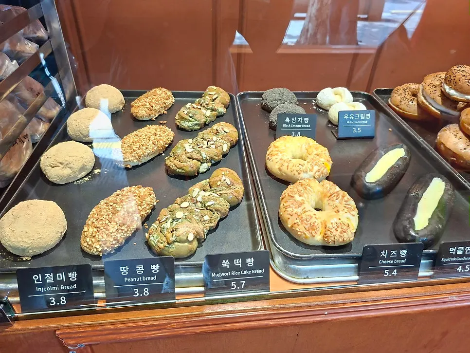 Various breads displayed on the shelves at Munhwa Bakery
