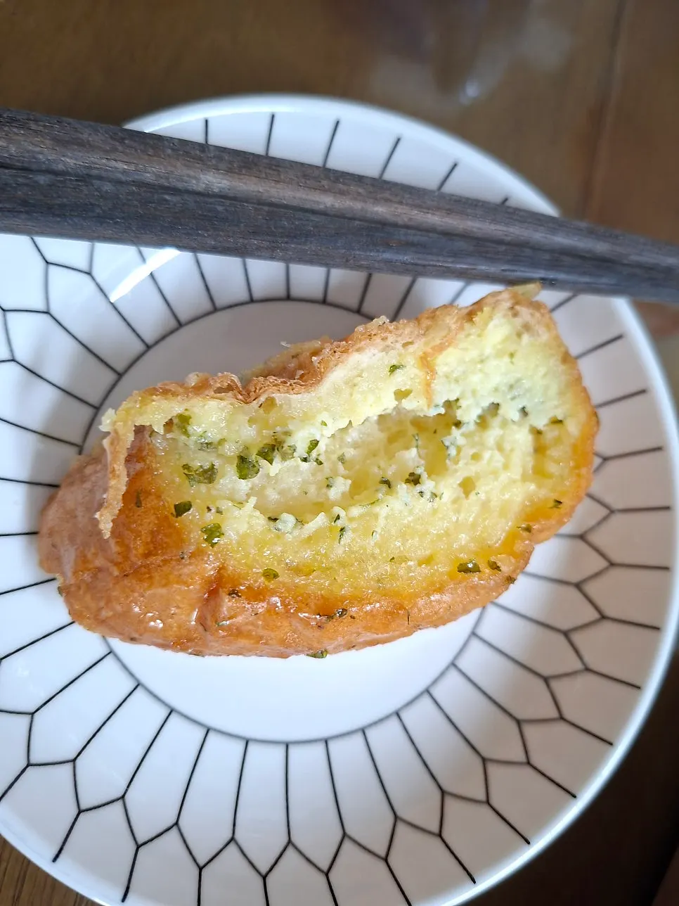 Cross-section of garlic bread with garlic butter cream soaked through