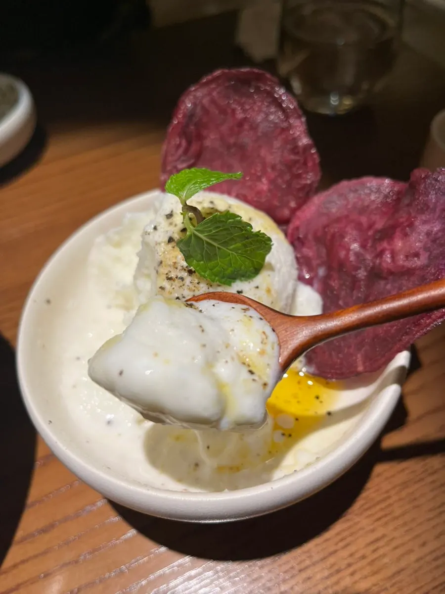 A spoonful of rice gelato topped with perilla oil
