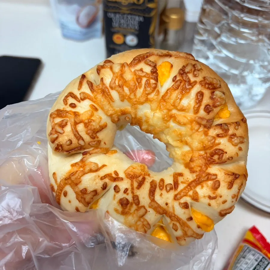 Cheese bagel with melted cheese on the outside