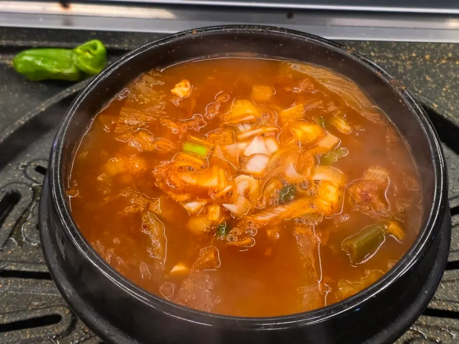 Pork belly grilling on the pan at Cham Dwaejitgan Jongno Main Branch