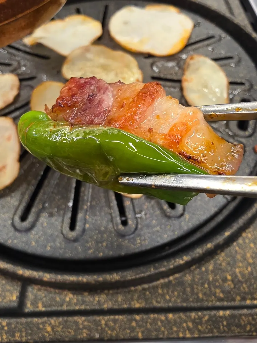 Black pork belly wrapped in lettuce leaves