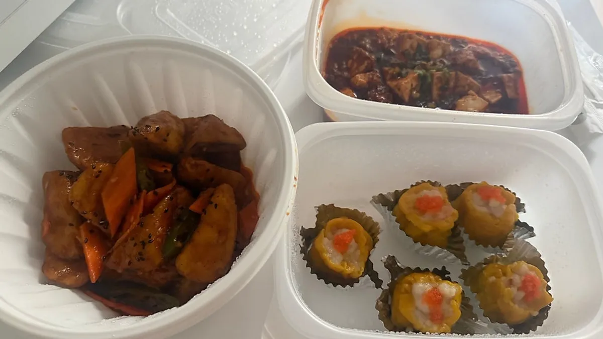Cheonghwa Uyuk Dosakmyeon takeout spread of mala tofu, eggplant fry, and shumai