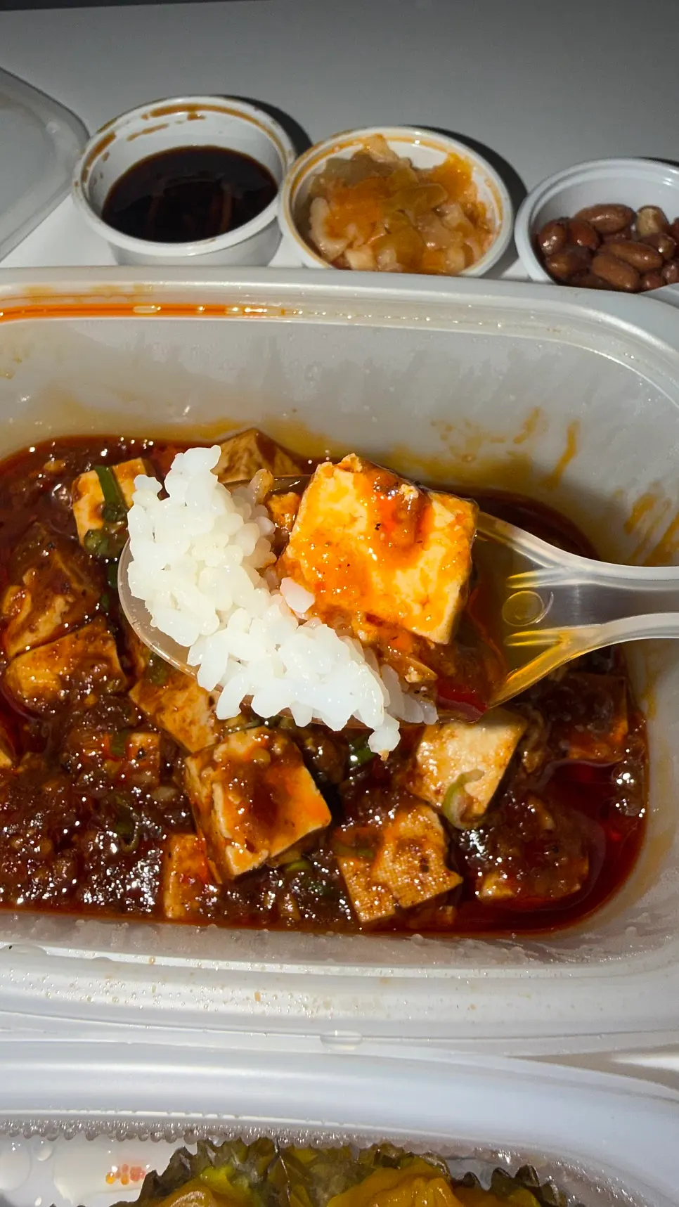Close-up of mala tofu loaded with rich sauce