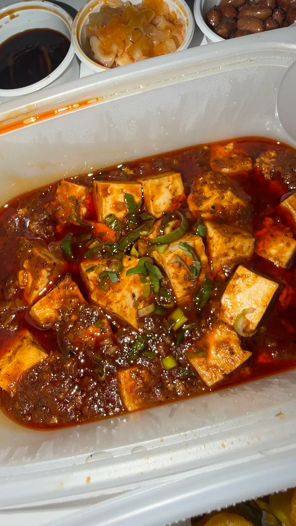 Mala tofu spooned over white rice