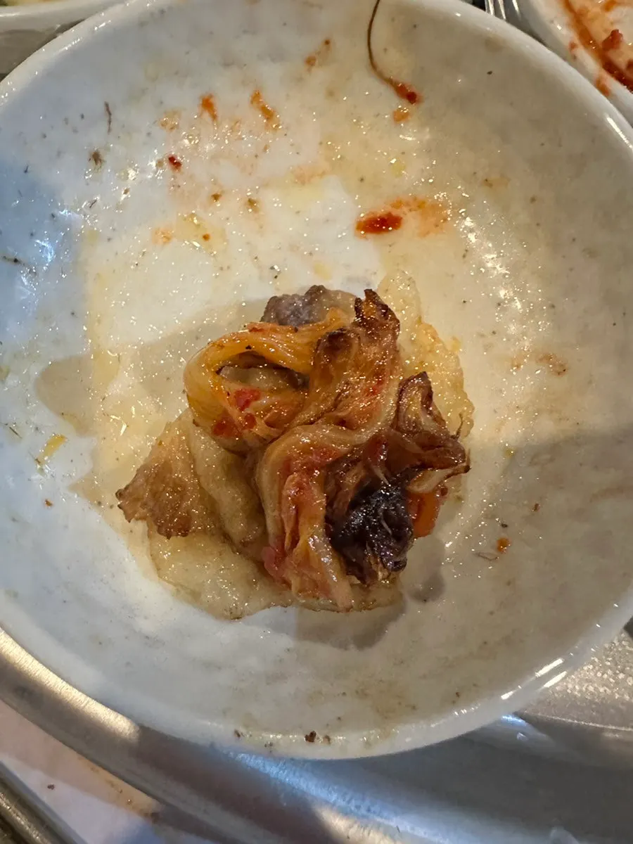 A bite of pork belly, kimchi, and gosari