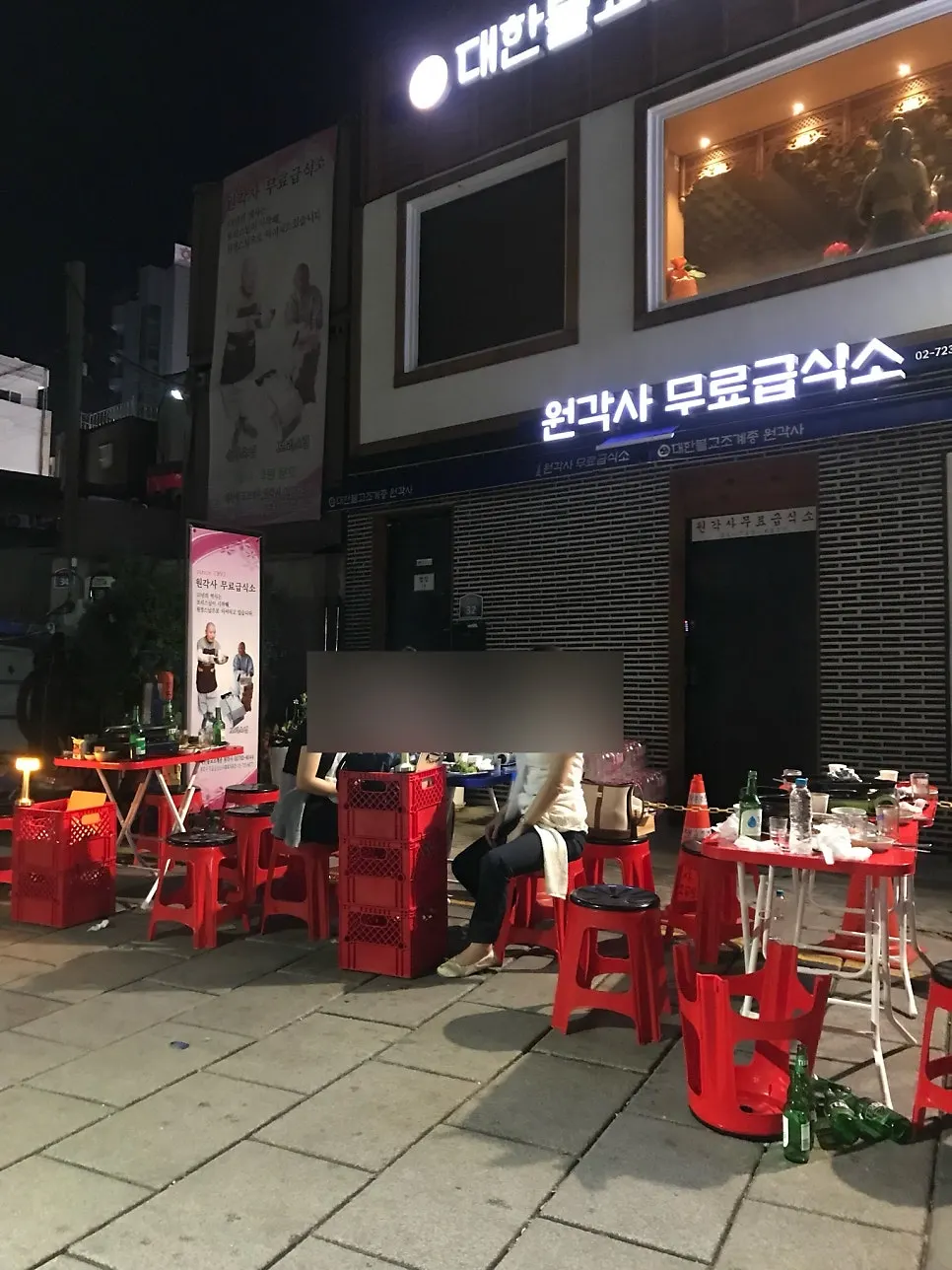 밤에 조명 켜진 초원식당 야장 골목
