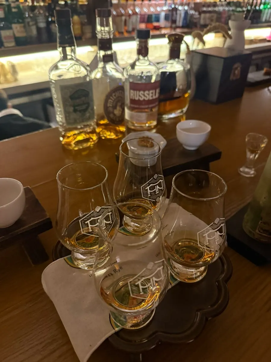 Four dedicated whisky tasting glasses lined up on the bar