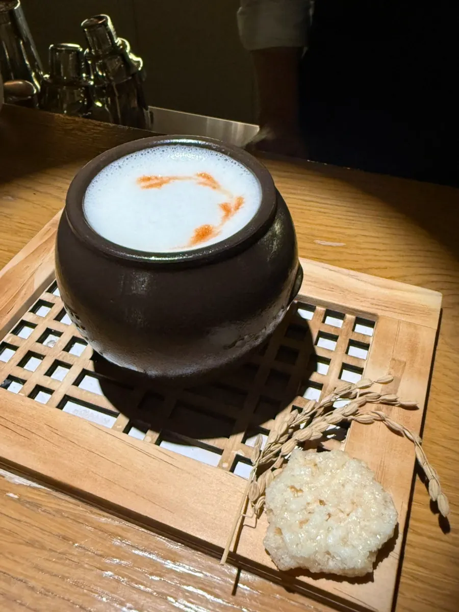 A Hanuk cocktail served in a black ceramic cup