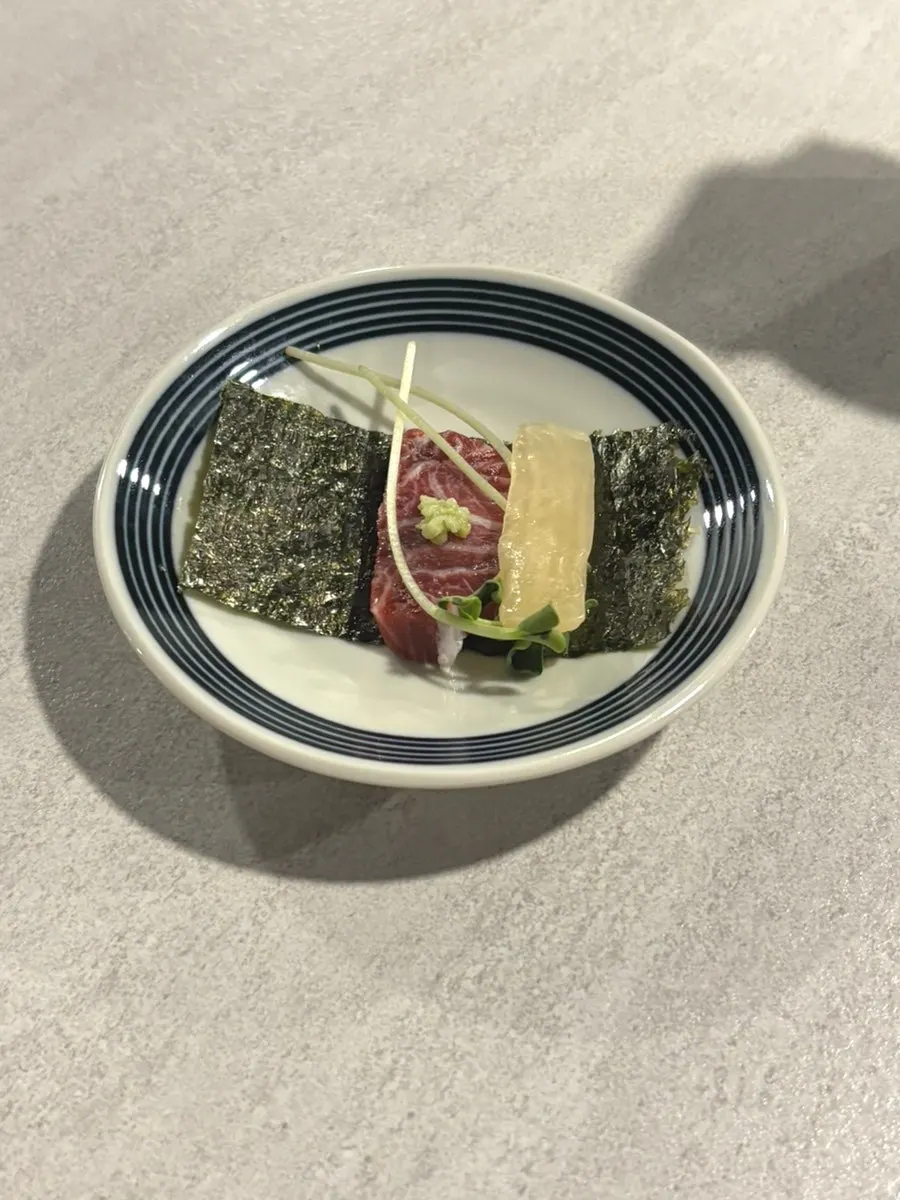 A piece of tuna picked up in the recommended eating order