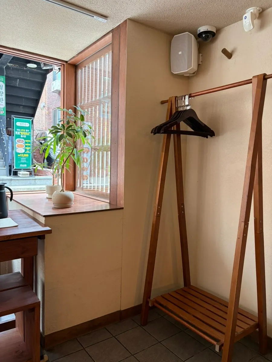 Coat hooks set up next to the wooden tables