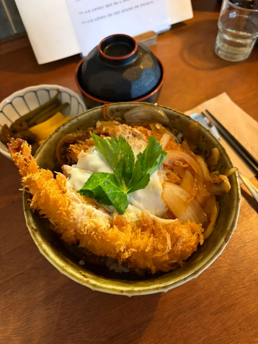 Rice bowl with soy-pickled onions layered under the rice