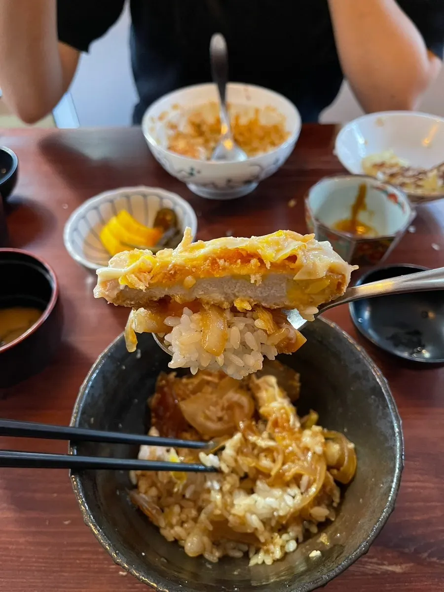 Mix katsu-don eaten with sauce-soaked rice