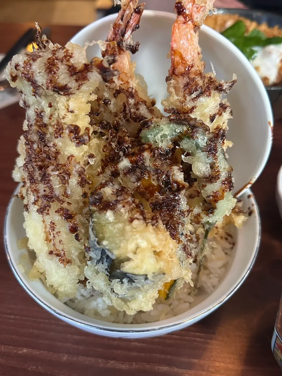 A bowl of mix katsu-don partway through the meal
