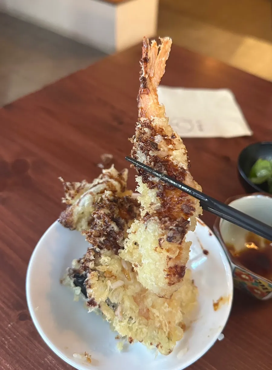 Cross-section of tempura in tendon with sauce-soaked rice