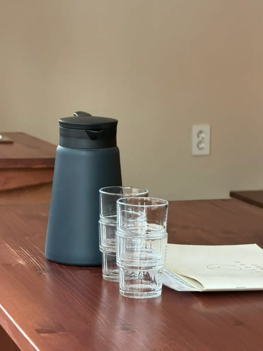 Table set with water, cups, and the menu