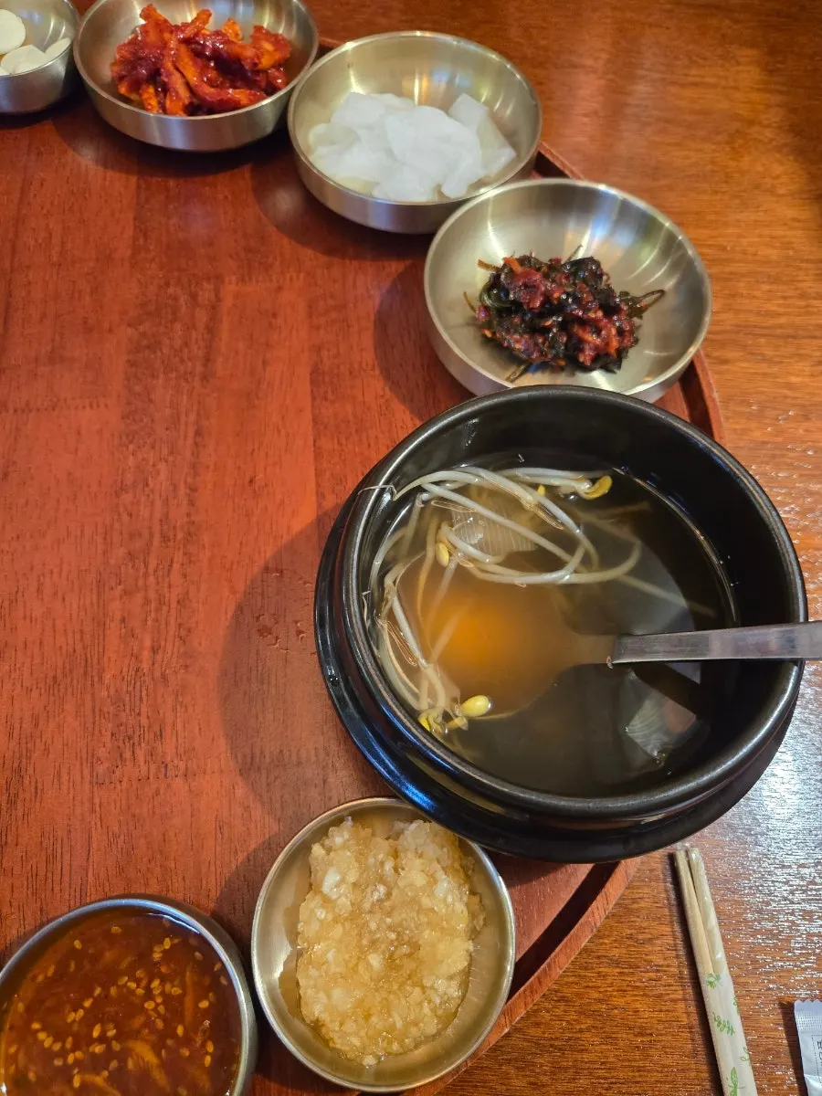Bean sprout soup and dried radish strips on the tabletop spread