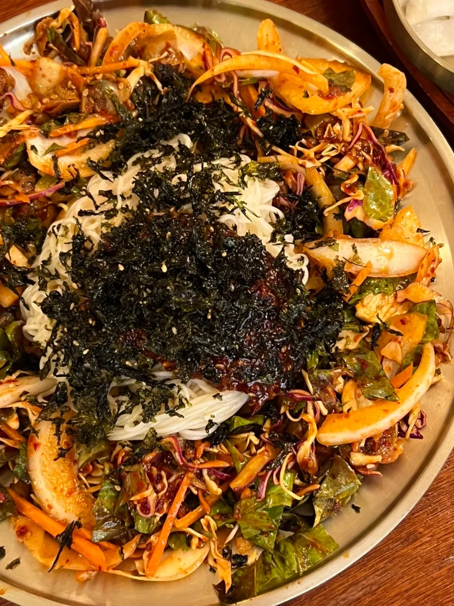 Bibim somyeon topped generously with Yeosu cockles