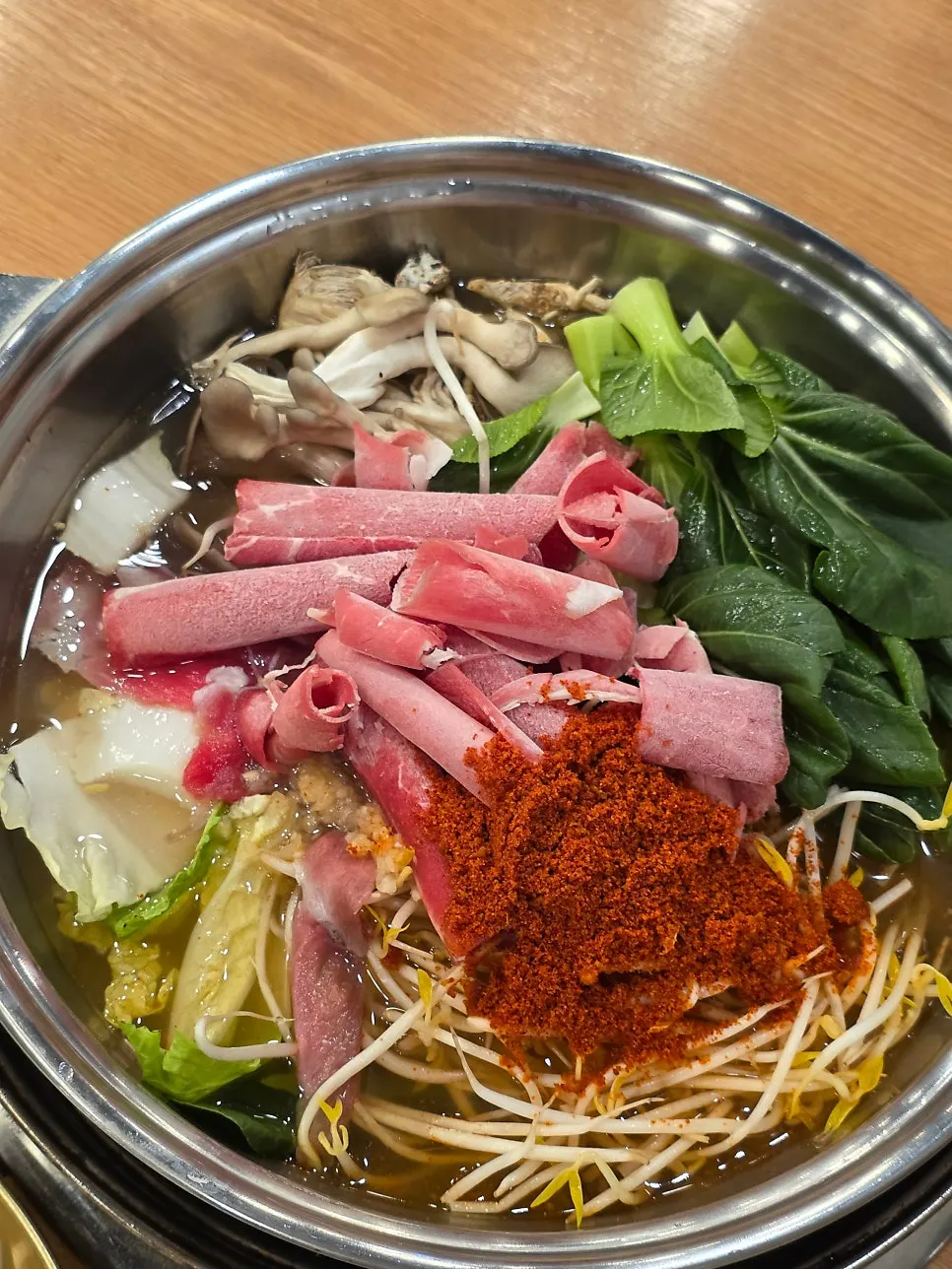 Spicy mandu hot pot served uncooked