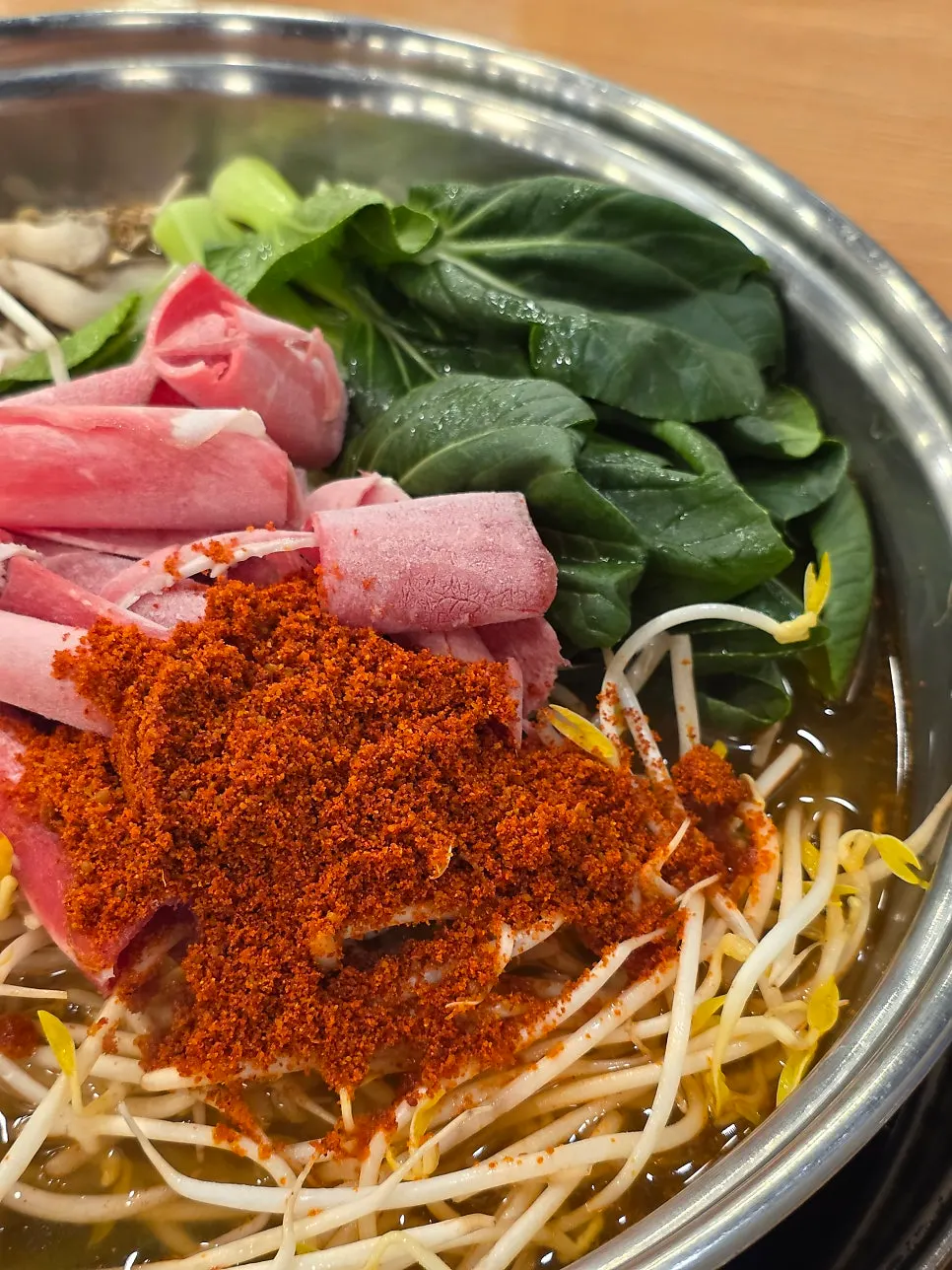 Spicy hot pot broth topped with red pepper flakes
