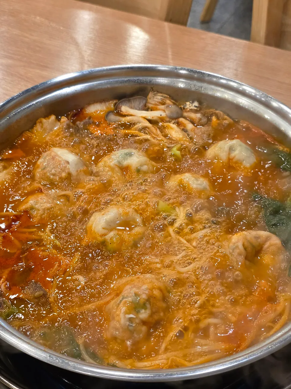 Handmade dumplings simmering in the hot pot