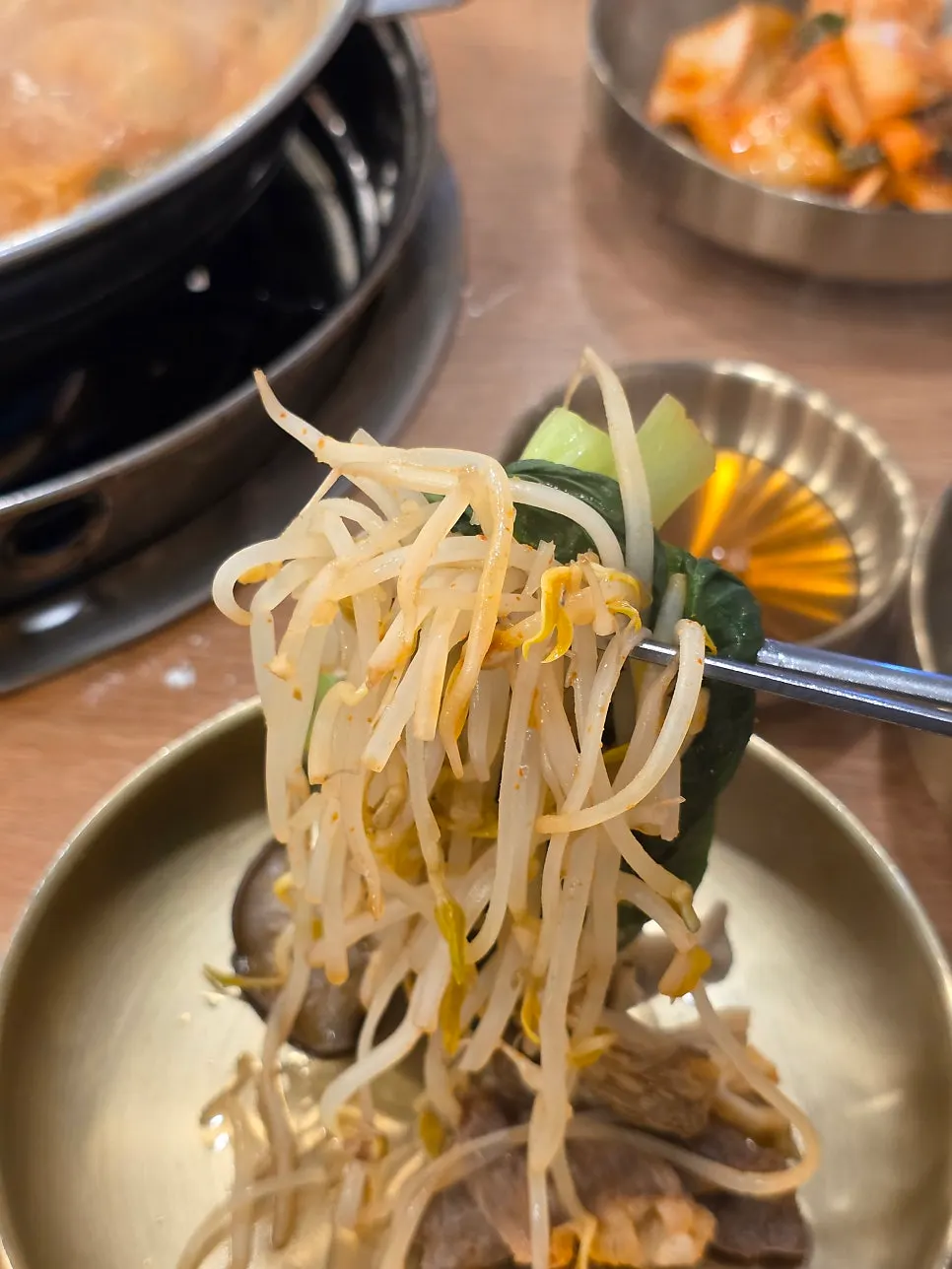 A ladle of the sharp hot pot broth