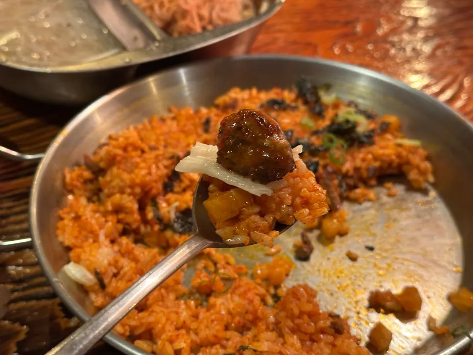 A piece of meat paired with sauce and side dishes