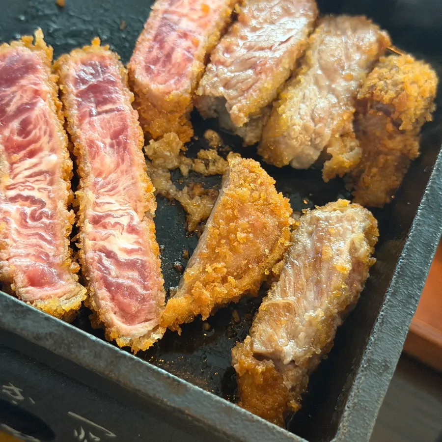 Grilling gyukatsu on a butter-topped brazier
