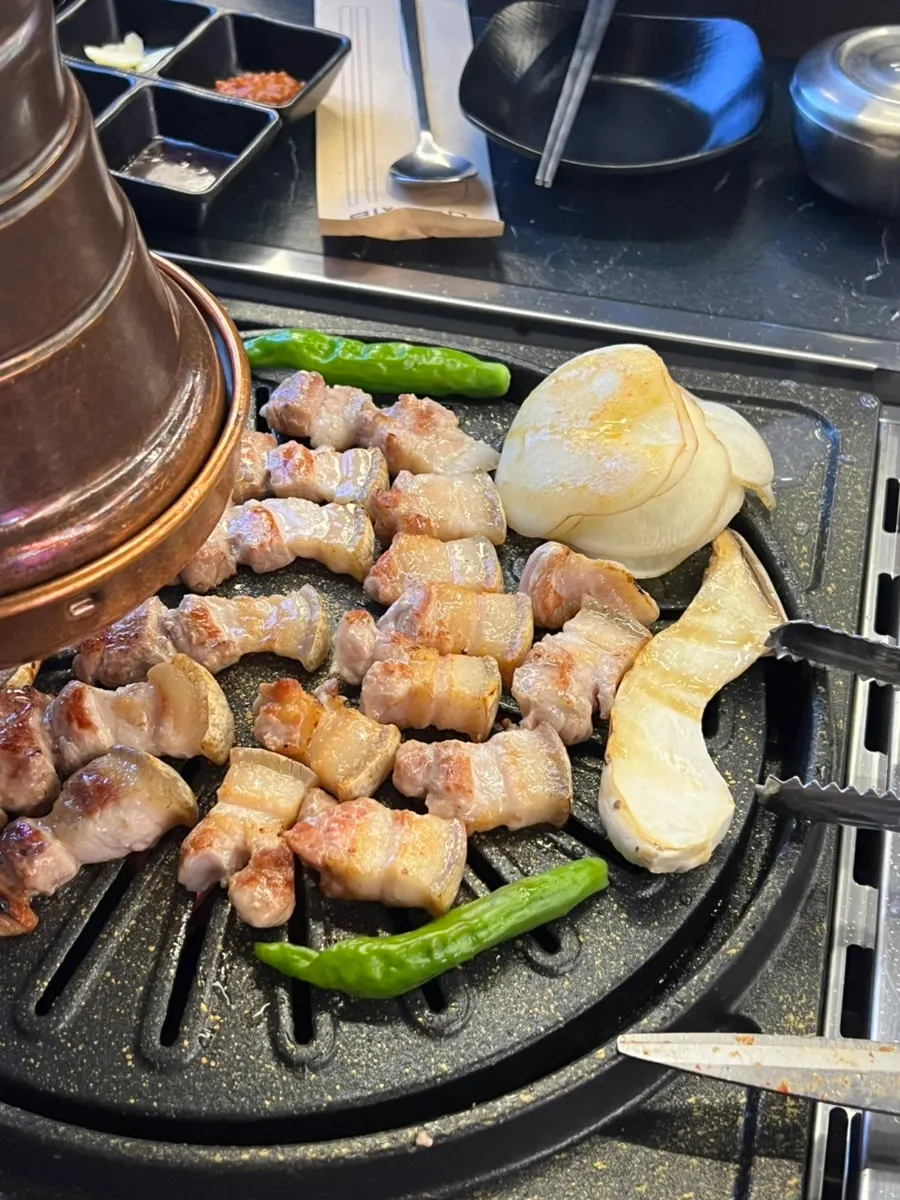Black pork five-layer pork belly cooking on the grill