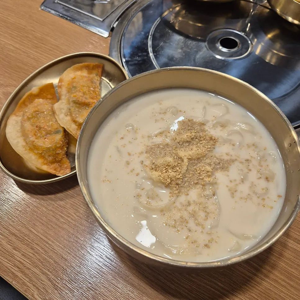 Table setting with soybean kalguksu and fried mandu set