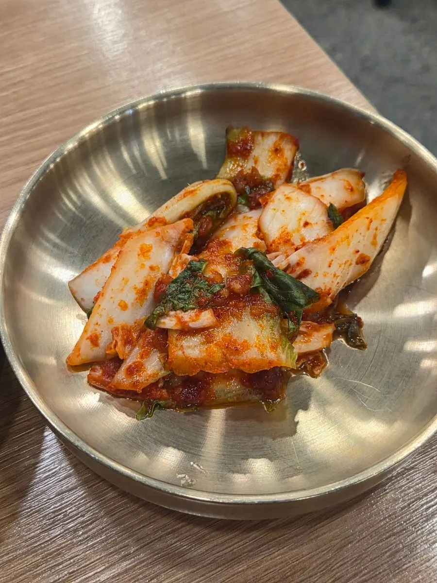 Basic side dishes of fresh cut kimchi and pickled radish